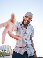 Image showing Portrait, happy black man and helping hand, offer and invitation outdoor in low angle mockup. Smile, palm and African person giving assistance in support, care and acceptance of handshake to welcome