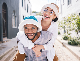 Image showing Happy couple, love or piggyback portrait in city to travel on romantic date to play a funny outdoor game. Smile, interracial or happy man carrying gen z woman in silly, goofy or playful joke together