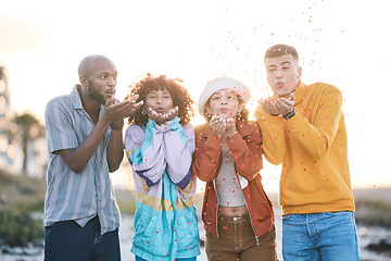 Image showing Friends, outdoor and people blowing confetti outdoor for celebration, motivation and fun. Diversity, happiness and group of men and women for adventure, party and happy youth with freedom in nature