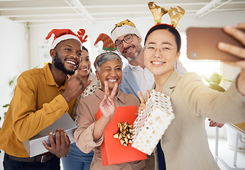 Image showing Business people, Christmas selfie and staff for smile, present or peace sign for celebration, diversity or party. Men, women and photography for funny xmas memory, friends or gift for social media