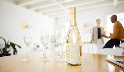 Image showing Alcohol, glass and champagne in office for celebration for achievement, goals and promotion. Corporate, company party and liquor drink on table for success, congratulations and toast for business