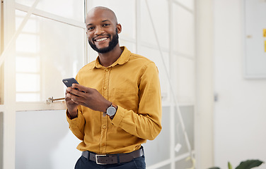 Image showing Happy black man, portrait and typing on smartphone in office for social media, networking and mobile contact. Business employee with phone, reading tech notification and information with digital chat