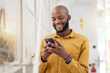 Image showing Happy black man, smartphone and typing in office for social media, networking and mobile contact. Business employee smile with cellphone, reading tech notification and information on digital news app