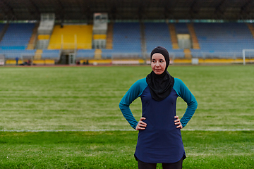 Image showing A Muslim woman with a burqa, an Islamic sportswoman resting after a vigorous training session on the marathon course. A hijab woman is preparing for a marathon competition