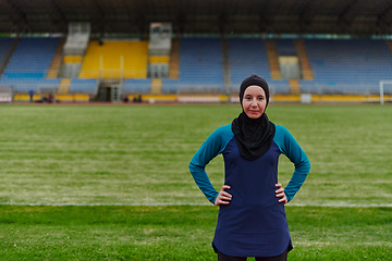 Image showing A Muslim woman with a burqa, an Islamic sportswoman resting after a vigorous training session on the marathon course. A hijab woman is preparing for a marathon competition