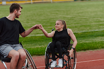 Image showing A woman with disability in a wheelchair talking with friend after training on the marathon course