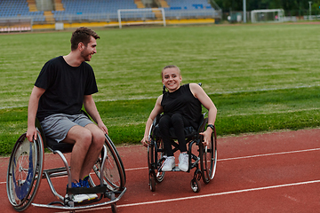 Image showing A woman with disability in a wheelchair talking with friend after training on the marathon course