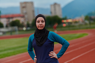 Image showing A Muslim woman with a burqa, an Islamic sportswoman resting after a vigorous training session on the marathon course. A hijab woman is preparing for a marathon competition