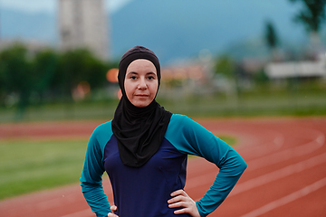 Image showing A Muslim woman with a burqa, an Islamic sportswoman resting after a vigorous training session on the marathon course. A hijab woman is preparing for a marathon competition