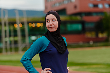 Image showing A Muslim woman with a burqa, an Islamic sportswoman resting after a vigorous training session on the marathon course. A hijab woman is preparing for a marathon competition