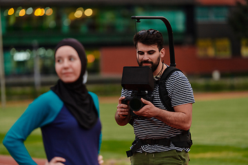 Image showing A cameraman filming the participants of the Paralympic race on the marathon course