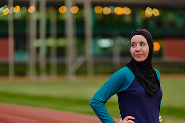 Image showing A Muslim woman with a burqa, an Islamic sportswoman resting after a vigorous training session on the marathon course. A hijab woman is preparing for a marathon competition