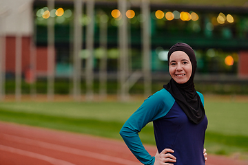 Image showing A Muslim woman with a burqa, an Islamic sportswoman resting after a vigorous training session on the marathon course. A hijab woman is preparing for a marathon competition