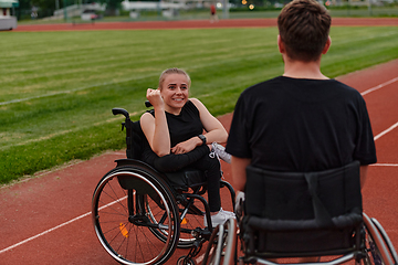 Image showing A woman with disability in a wheelchair talking with friend after training on the marathon course