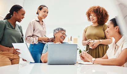 Image showing Happy fashion designers, teamwork or women with laptop for planning or online draft for clothing line. Smile, computer or group of employees talking to a funny mature mentor for advice in internship