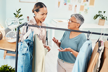 Image showing Consultant, fashion and shopping with client in shop for advice on fabric or products on promotion. Customer, retail sale or women talking in boutique mall for clothes deal, help or discount offer