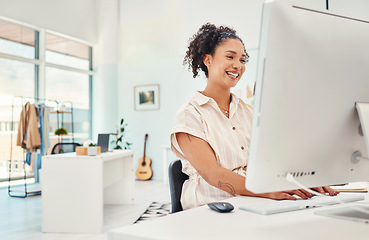 Image showing Computer, fashion and design with a creative woman at work in her office for modern or artistic style. Smile, workshop and technology with a happy young designer working in a studio for creativity