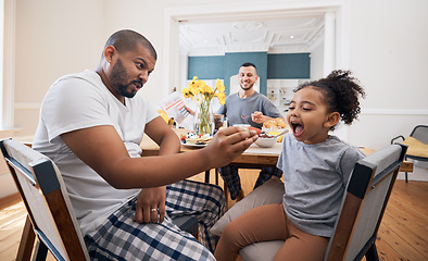 Image showing Gay couple, breakfast and father feeding child meal, food or morning cereal for youth development in home dining room. Family bond, adoption or homosexual dad smile for hungry kid girl eating