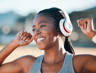 Image showing Black woman, smile and headphones, music and fitness outdoor with running, race and athlete, wellness and sport. Happy runner, audio streaming and exercise with workout, health and training for race