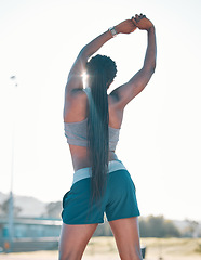 Image showing Stretching, exercise and sports woman outdoor at a stadium for workout, training and warm up. Back of athlete person for muscle stretch, fitness and wellness or flexibility for a run or competition