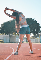 Image showing Exercise, stretching and sports woman outdoor at a stadium for workout, training and warm up. Back of athlete person for muscle stretch, fitness and wellness or flexibility for a run or competition