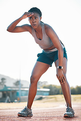 Image showing Sweating, tired and black woman at stadium for a race, training or breathing after cardio. Sports, workout and an athlete or African runner with a break after fitness, running or exercise on a track