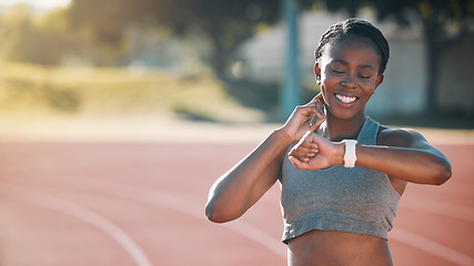 Image showing Time, watch and exercise with a woman outdoor on a track for running, training or workout. African athlete person at stadium for goals, fitness and body wellness or check pulse for progress and space