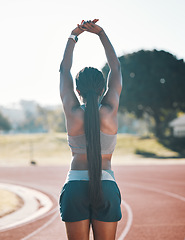 Image showing Sports, stretching and exercise with a woman outdoor on a track for running, training or workout. Behind African athlete person at stadium for arm stretch, fitness and muscle warm up or body wellness