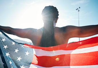 Image showing Athlete, American flag and sports with a woman outdoor at a stadium to celebrate country, pride and win. Back of a person for olympic sport, fitness and exercise achievement at competition in USA