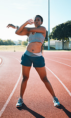 Image showing Woman, sports and exercise or stretching outdoor on a track for running, training or workout. African athlete person at stadium for arm stretch, fitness and muscle warm up or body wellness