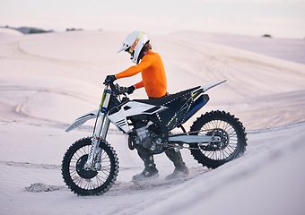 Image showing Bike, sand and freedom with a sports man pushing a vehicle in the desert for adventure or adrenaline. Motorcycle, training and dunes with an athlete outdoor in nature for power or active competition