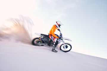 Image showing Bike, dust and motion blur with a sports man riding a vehicle in the desert for adventure or adrenaline. Motorcycle, training and speed with an athlete on sand in nature for speed, freedom or energy