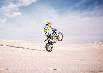 Image showing Bike, space and balance with a sports man riding a vehicle in the desert for adventure or adrenaline. Motorcycle, training or freedom and an athlete on sand in nature for skill or power with mockup