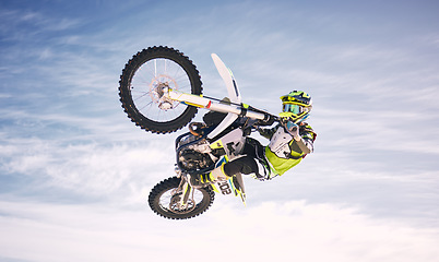 Image showing Sky, jump and man on off road motorbike for practice, training and extreme sports energy in nature. Professional dirt biking adventure challenge, person in clouds and danger in motorcycle competition