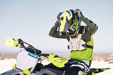 Image showing Sports, action and man on motorbike in desert for training, workout and race challenge on sand. Extreme transport, travel and cyclist with helmet on motorcycle for adventure, freedom and adrenaline