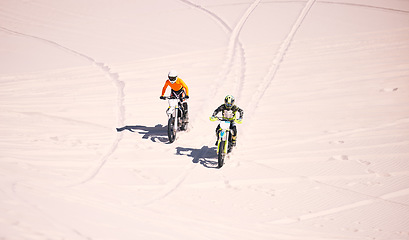 Image showing Dune, off road and men on motorbike together for practice, training and extreme sports energy in nature. Professional dirt biking challenge, friends and danger with motorcycle competition in desert.