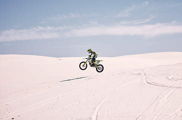 Image showing Bike, mockup and balance with a man in the desert riding a vehicle for adventure or adrenaline. Motorcycle, space and training on sand with an athlete outdoor in nature for freedom or active power