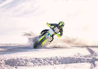 Image showing Motorcycle, dust and speed with a man in the desert riding a vehicle for adventure or adrenaline. Bike, training and freedom with an athlete outdoor on sand in nature for power or extreme sports
