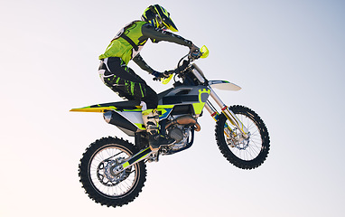 Image showing Jump, adventure and man on motorbike with blue sky for practice, training and extreme sports energy. Professional dirt biking challenge, person and danger with off road motorcycle stunt competition.