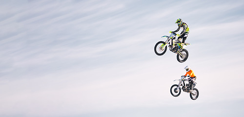 Image showing Sky, jump and men on motorbike together for practice, training and extreme sports energy in mockup. Professional dirt biking challenge, friends in air and danger with off road motorcycle competition.