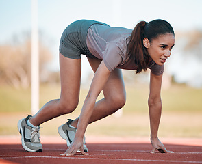 Image showing Woman, fitness and running start in athletics, motivation or competition on stadium or olympic track. Active female person or runner ready in sprint marathon, cardio workout or outdoor performance