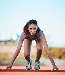 Image showing Woman, portrait and start of running athlete in sports fitness, exercise or motivation on stadium track. Serious female person or runner ready in race, sprint marathon or cardio workout and training