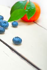 Image showing tangerine and blueberry on white table