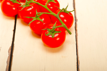 Image showing fresh cherry tomatoes on a cluster