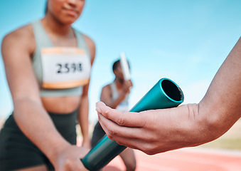 Image showing Woman, team and hands with baton in relay, running marathon or sports fitness on stadium track. Closeup of people holding bar in competitive race, sprint or coordination for teamwork or performance