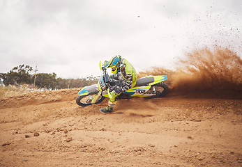 Image showing Desert, dirt and motorbike cycling for sports, agile driving and off road adventure with speed, power and mockup space on cloudy sky. Motorcycle, rally challenge and driver in fast race on sand dunes