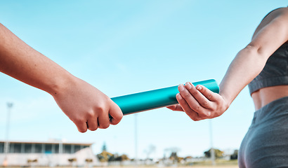 Image showing Person, team and hands with baton in relay, running marathon or sports fitness on stadium track. Closeup of people holding bar in competitive race, sprint or coordination in teamwork performance