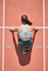 Image showing Start, running and fitness with woman on race track from above for sports, competition and marathon. Exercise, health and wellness with runner in stadium for challenge, speed and energy performance