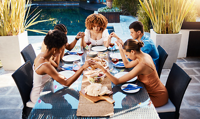 Image showing Holding hands, food and people pray outdoor at table for gratitude and holiday celebration. Group of friends together at lunch, party or reunion with drinks in garden for thanks, prayer and grace