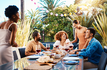 Image showing Happy people, friends and food outdoor on a table for social gathering, happiness and holiday celebration. Diversity, men and women group eating lunch at party or event with wine to relax in garden